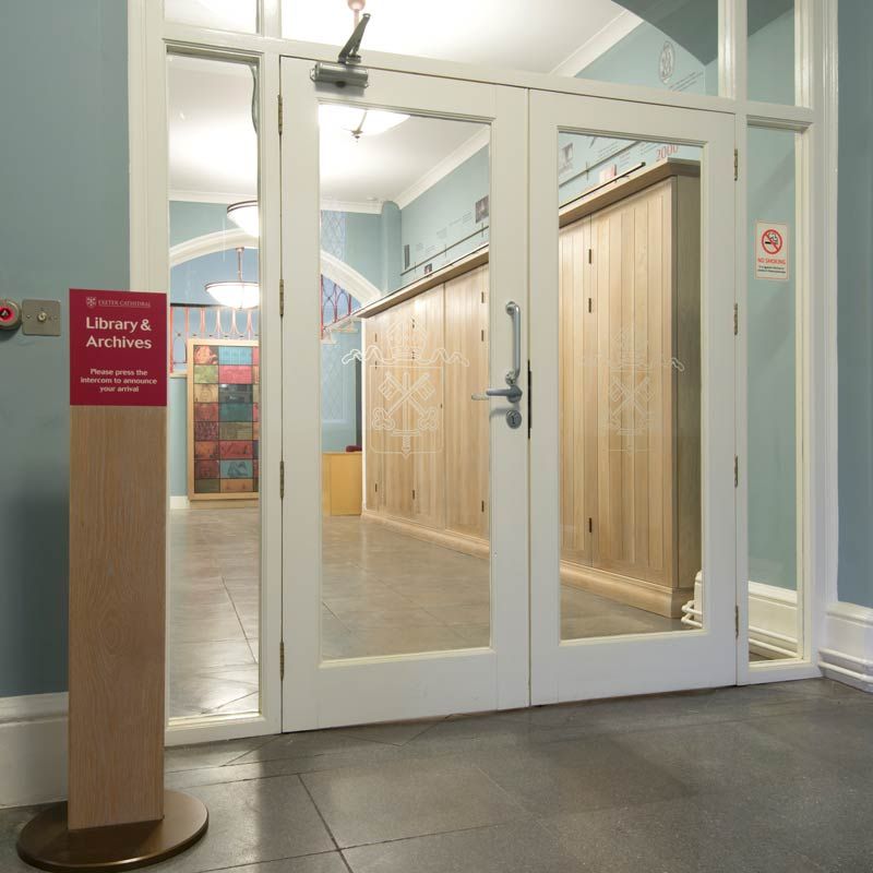 Exeter Cathedral Library & Archives entrance, with exhibition units in background