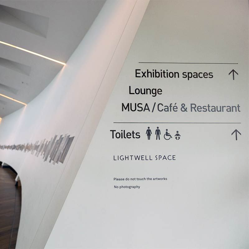 Firstsite Exhibition spaces, lounge, ad MUSA wayfinding signage