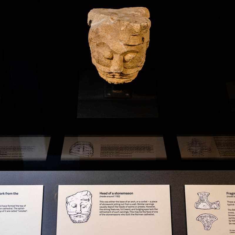 Bath Abbey Discovery Centre exhibit showing stonework entitles 'Head of a stonemason'